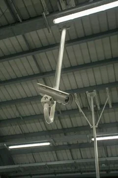 Cctv security camera at a train terminal at night time at train station Stock Photos