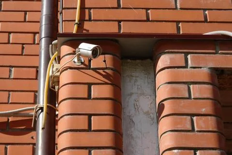 CCTV security camera on the wall outside. Stock Photos
