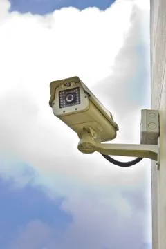 CCTV security camera at the wall. Stock Photos