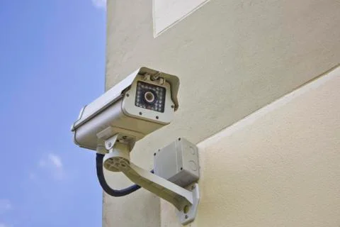 CCTV security camera at the wall. Stock Photos
