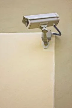 CCTV security camera at the wall. Stock Photos