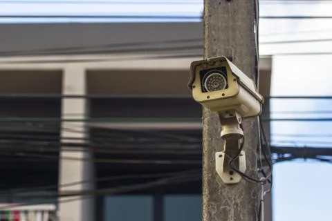 CCTV security video camera protect on the electricity with building as backgr Stock Photos