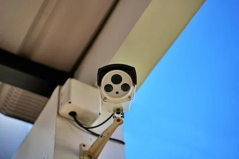 CCTV surveillance security camera video equipment on pole outdoor building sa Foto stock