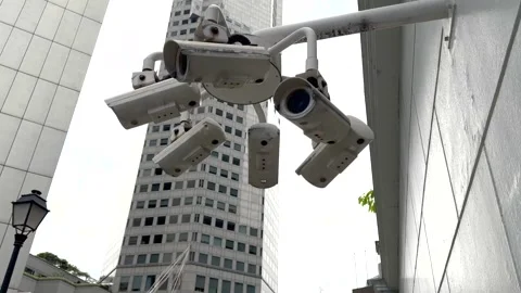 CCTV Video surveillance camera system scanning street in big city Stock Footage 302958231