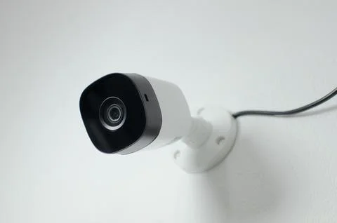 CCTV videocam, CFTV security camera, white camera with secure circuit, theft  库存照片