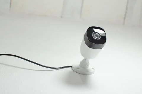 CCTV videocam, CFTV security camera, white camera with secure circuit, theft  库存照片