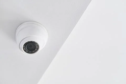 Cctv on white ceiling in modern building Stock Photos