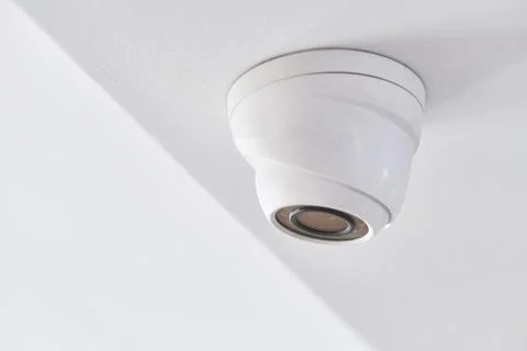 Cctv on white ceiling in modern building Stock Photos