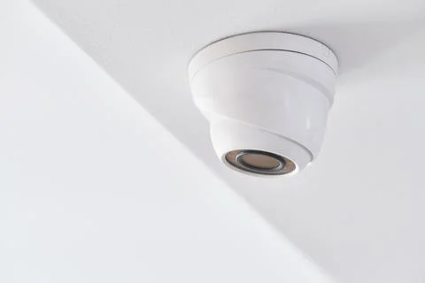 Cctv on white ceiling in modern building Stock Photos