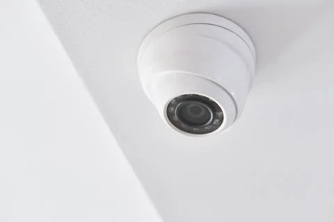 Cctv on white ceiling in modern building Stock Photos