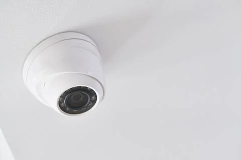 Cctv on white ceiling in modern building Stock Photos