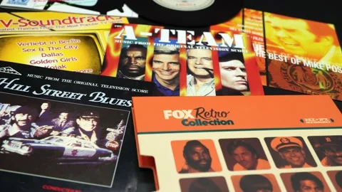 Cd and artwork of 80s and vintage TV series soundtracks Stock Footage 137974012