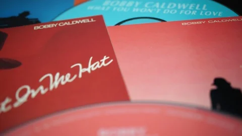 CD and artwork of CD and artwork of American singer BOBBY CALDWELL Stock Footage 119835790