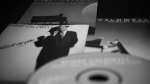 CD and artwork of CD and artwork of American singer-songwriter BOBBY CALDWELL Stock Footage 205415423