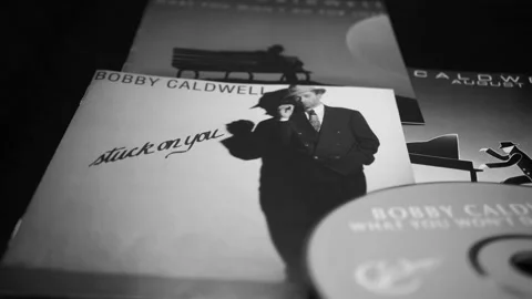 CD and artwork of CD and artwork of American singer-songwriter BOBBY CALDWELL Stock Footage 205415507