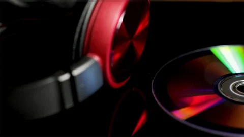 CD and headphones panoramic view close up. Shiny multicolored compact disc. Video stock 96773440