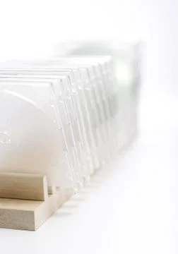 A CD cases standing on CD rack Stock Photos
