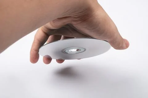 Cd compact disc in hand on white background Stockfoto's