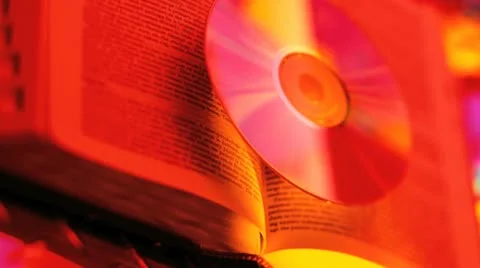 Cd hovering over a book Stock Footage 20545410