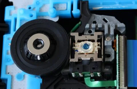 CD inside a DVD payer showing optical pick up laser lens with circuits Stock Photos