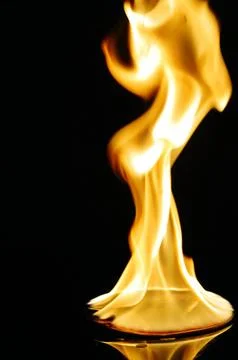 A CD or DVD disc burning in flames Stock Photos