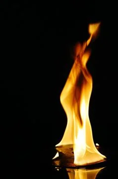 A CD or DVD disc burning in flames Stock Photos