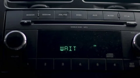 CD player in car inserting music compact disc into radio player. Video stock 237762123