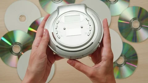 CD Player, Using headphone for old music portable compact player close-up Stock Footage 295143226