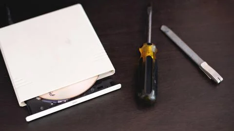 CD-ROM screwdriver, cutter bundle, computer repair equipment. Stock Photos