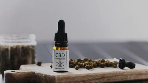 Cdb Dry Cannabis For Smaking And Bottle Of CBD Natural Oil On A Table Stock Footage 329226216