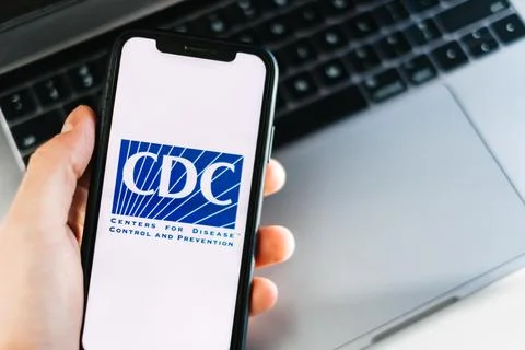 CDC Centers for Disease Control and Prevention logo on smartphone screen. Stock Photos