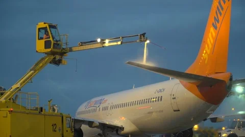 CDF 15 Sunwing Boeing 737 Early Morning Trucks Spraying Aircraft Left rear CU Stock Footage 76914701