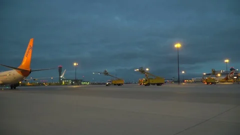CDF 15 Sunwing Boeing 737 Early Morning Trucks Approaching Aircraft WS Stock Footage 76920598