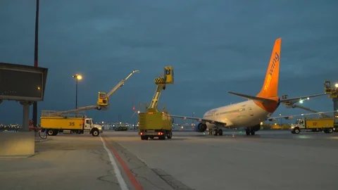 CDF 15 Sunwing Boeing 737 - Early Morning Trucks Approaching Aircraft CU Stock Footage 76929311