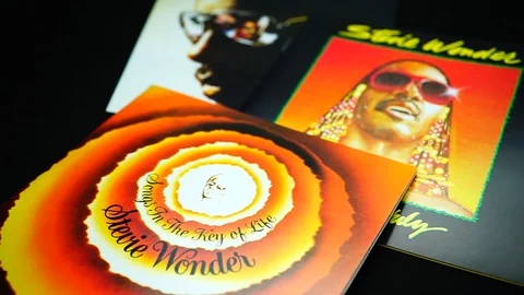 CDs and artwork of American singer, and multi-instrumentalis STEVIE WONDER Stock Footage 105431821