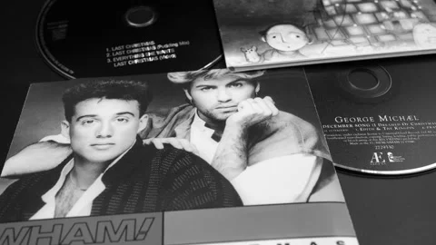 CDs and artwork of two Christmas singles by GEORGE MICHAEL Stock Footage 142482004