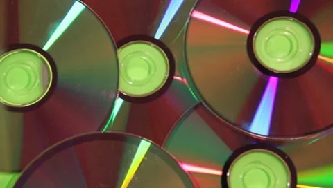 CD's and DVD's random pile up on green screen CD DVD #2 Stock Footage 7751328