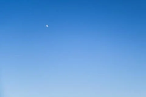 Cear blue sky without clouds with moon and airplane for background for nature Stock Photos