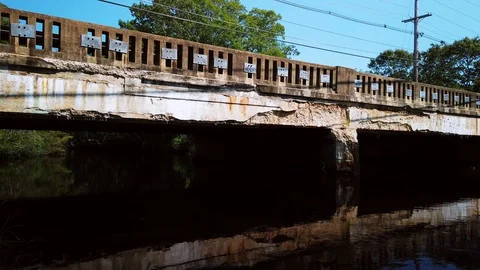 Cedar Creek water running under a Route 9 overpass Stock Footage 113486050