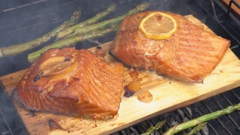 Cedar plank salmon with lemon cooking on grill Stock Footage 81062390