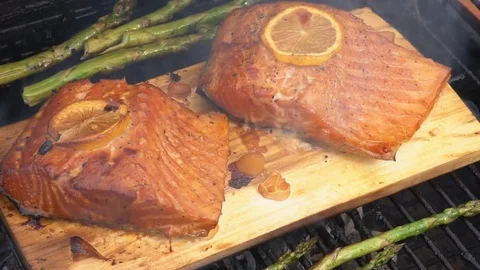 Cedar plank salmon with lemon cooking on grill Stock Footage 81062519