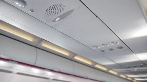 Ceiling of airplane cabin with load speaker, no smoking sign. Stock Footage 121242533