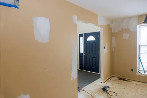 Ceiling and wall with damage spreading plaster to damaged wall, repairing wor Stock Photos