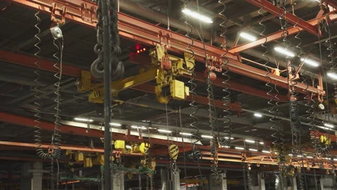 Ceiling of assembly shop with hoists and many tubes for pneumatic tools. Stock Footage 251706071