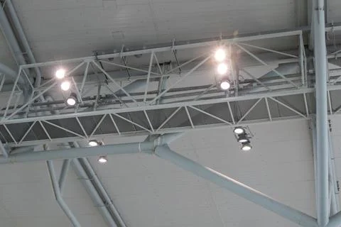Ceiling with bright lighting in a modern warehouse, shopping center building Stock Photos