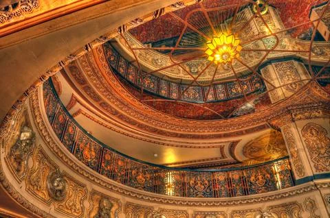 The ceiling of a building that has many colored paintings on it Illustrazione stock