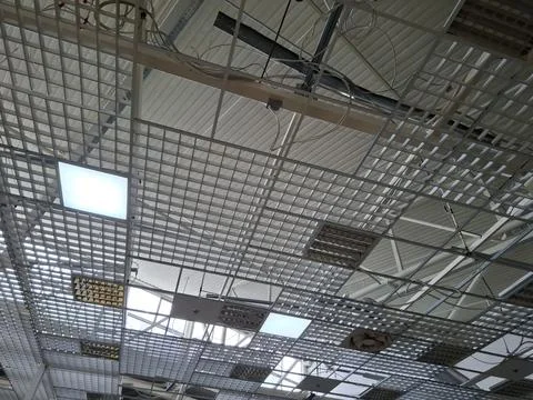 Ceiling in a business centre with ventilators and electric lamps Stock Photos