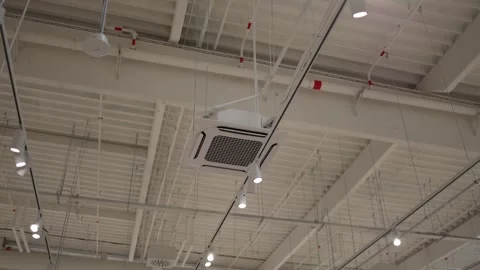 Ceiling cassette air conditioner with track lighting in a commercial interior Stock Footage 342913906