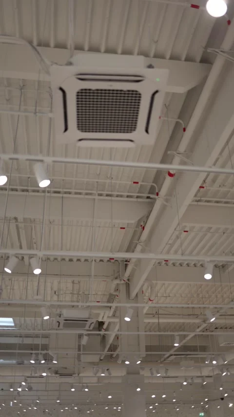 Ceiling cassette air conditioners installed inside a modern retail store Stock Footage 342912862