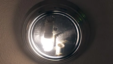 Ceiling with CFL light bulb is turned on and then turned off Stock Footage 296998356